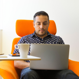 man-in-chair-on-laptop 500x500